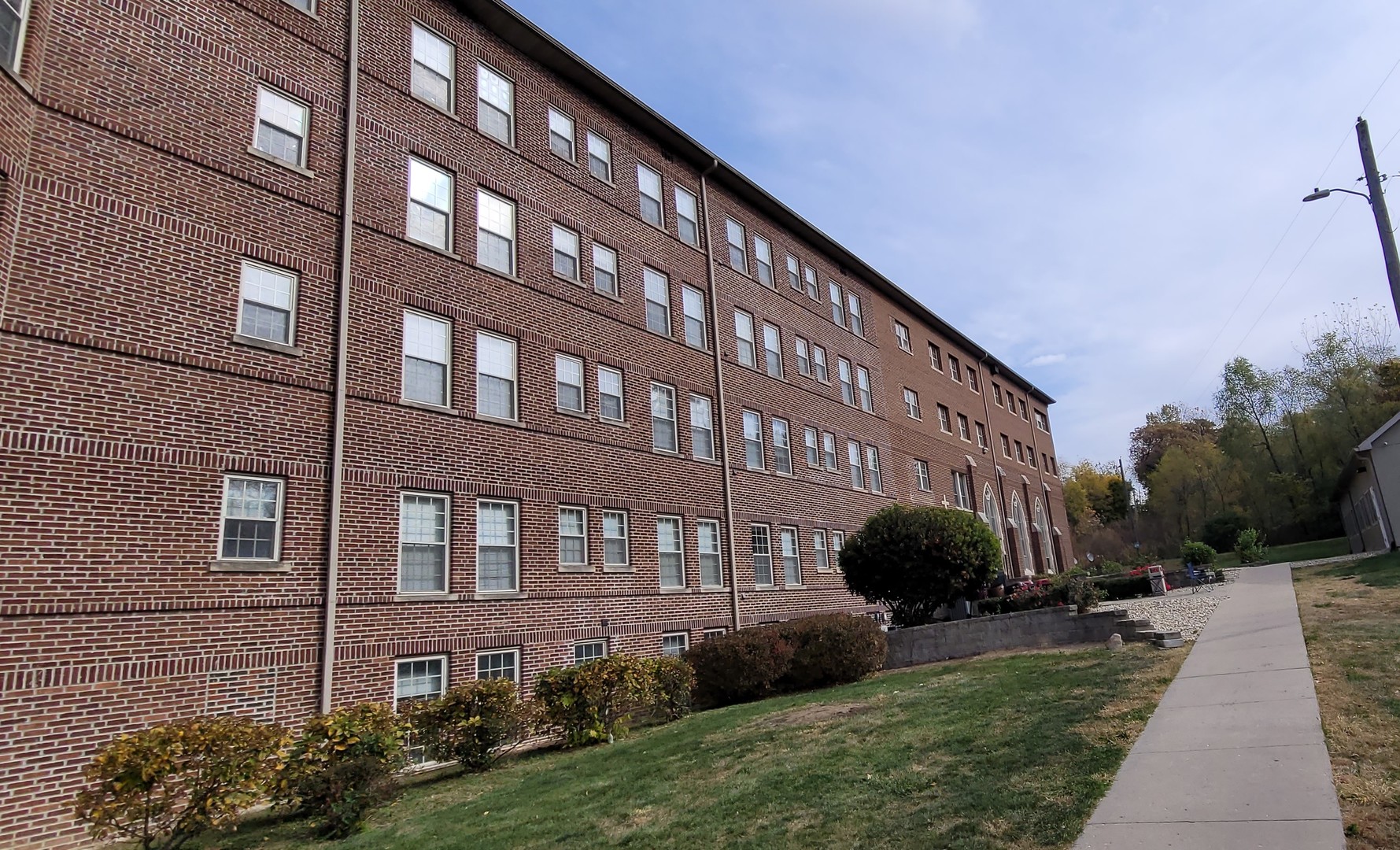 a view of a brick building next to a yard