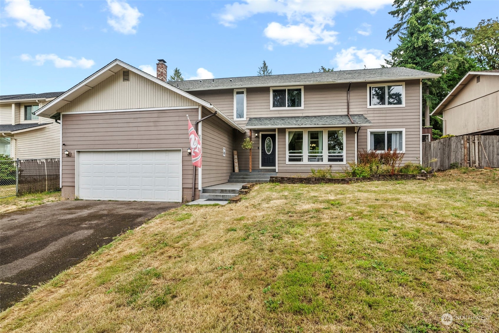 a front view of a house with a yard and garage