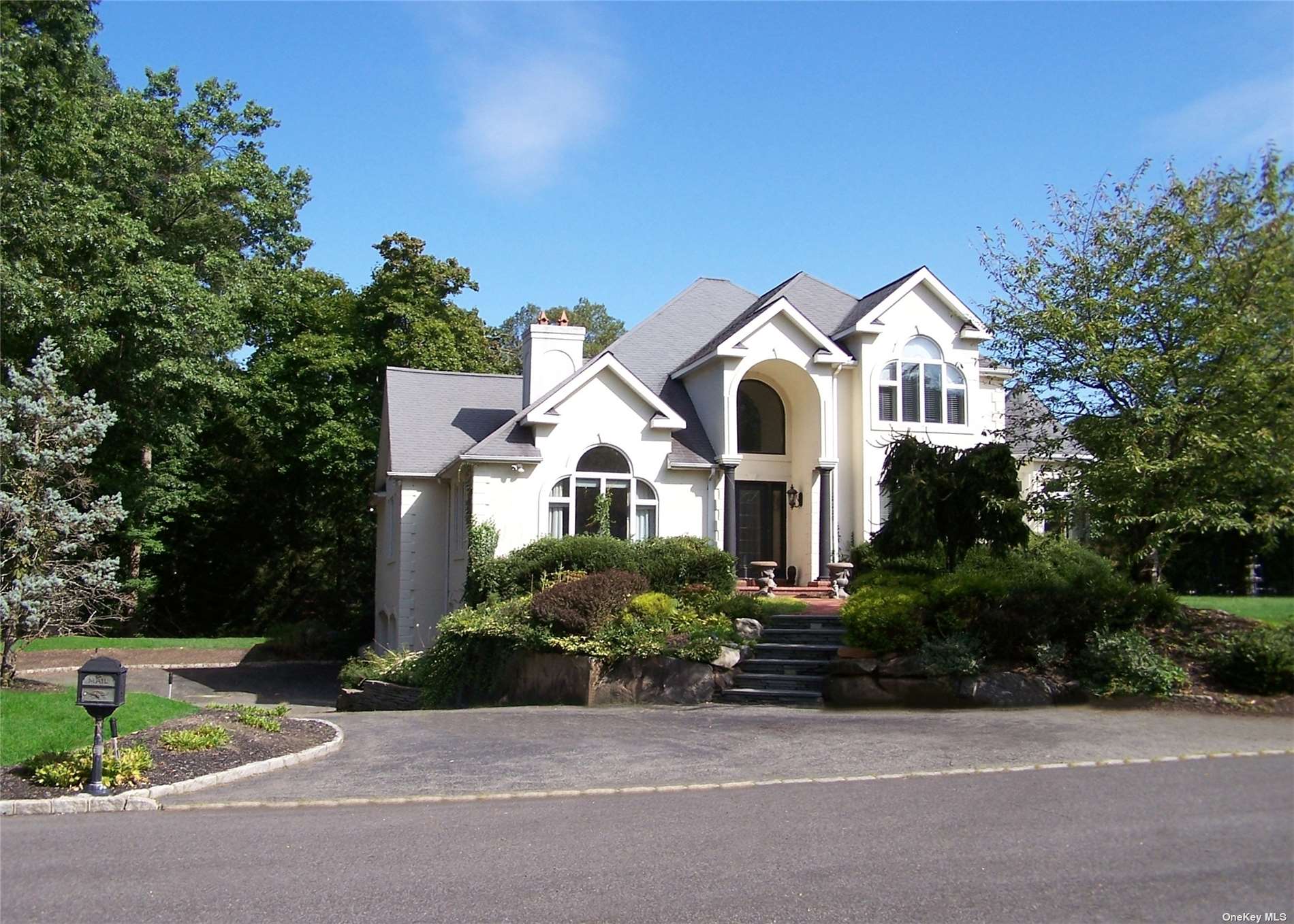 front view of a house with a garden