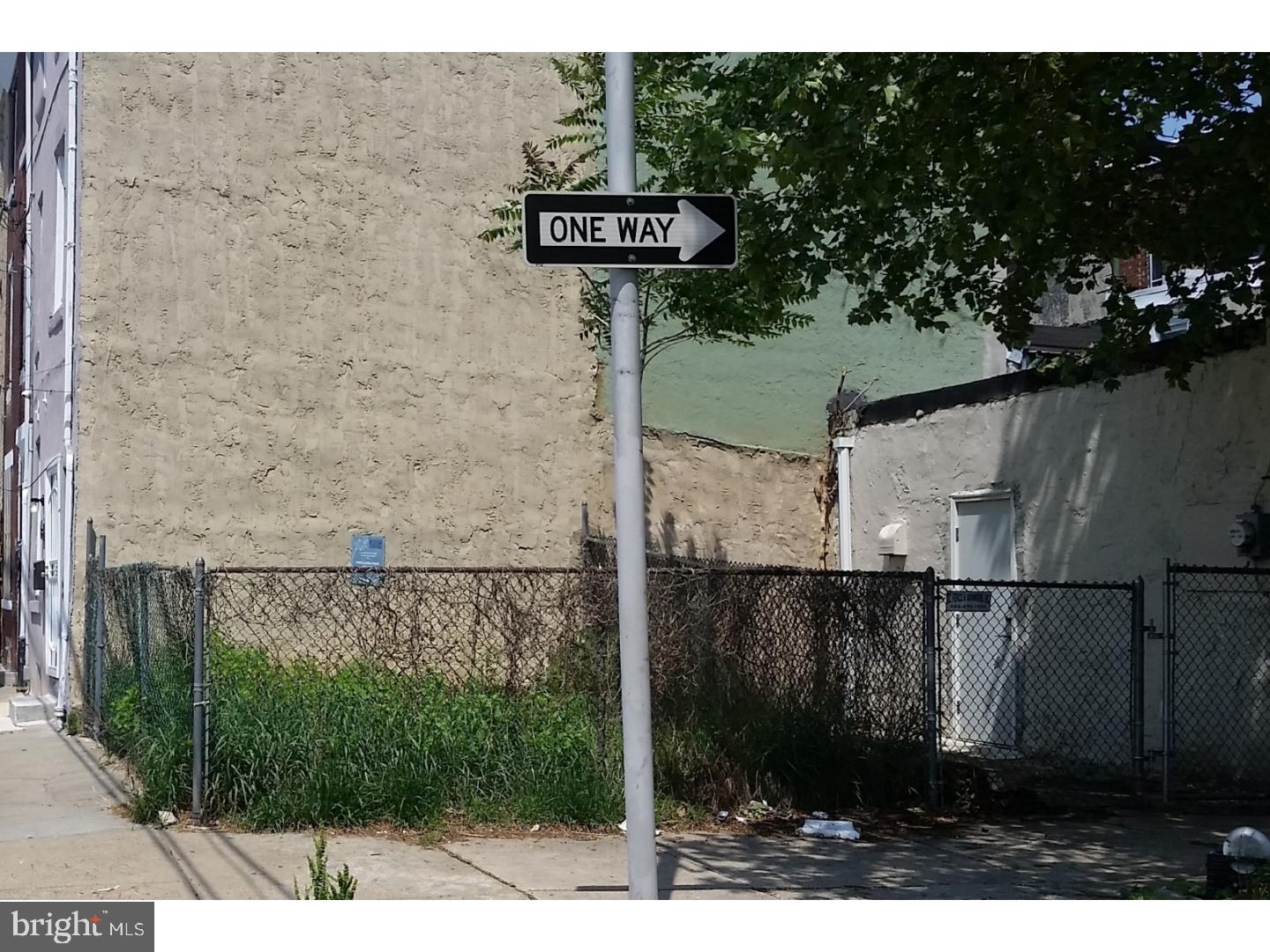 a view of a street sign on a wall next to a building