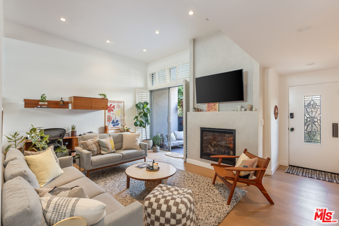 a living room with furniture fireplace and a flat screen tv