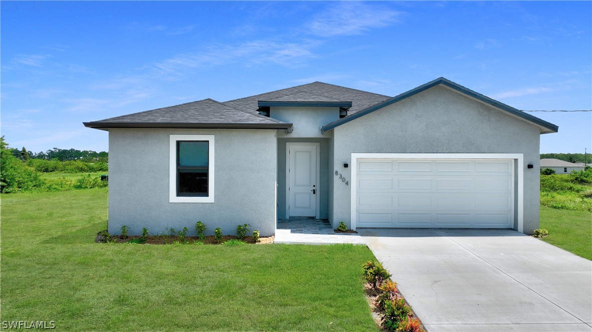 a front view of a house with a yard and garage