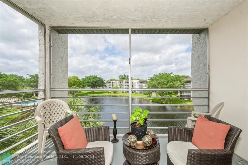 a view of a chair and tables on the roof deck