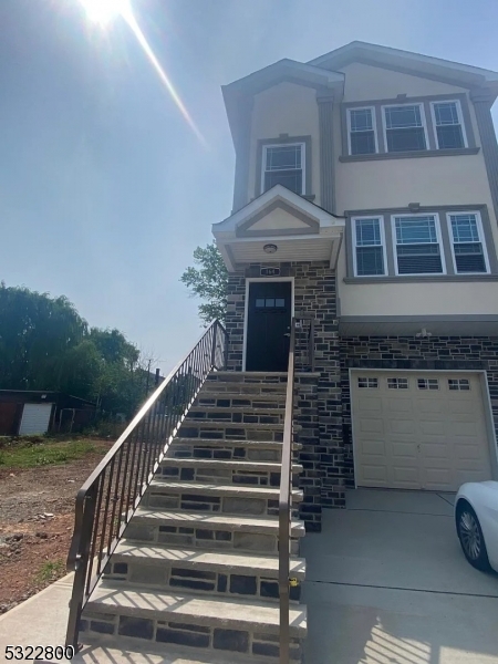 a front view of a house with stairs