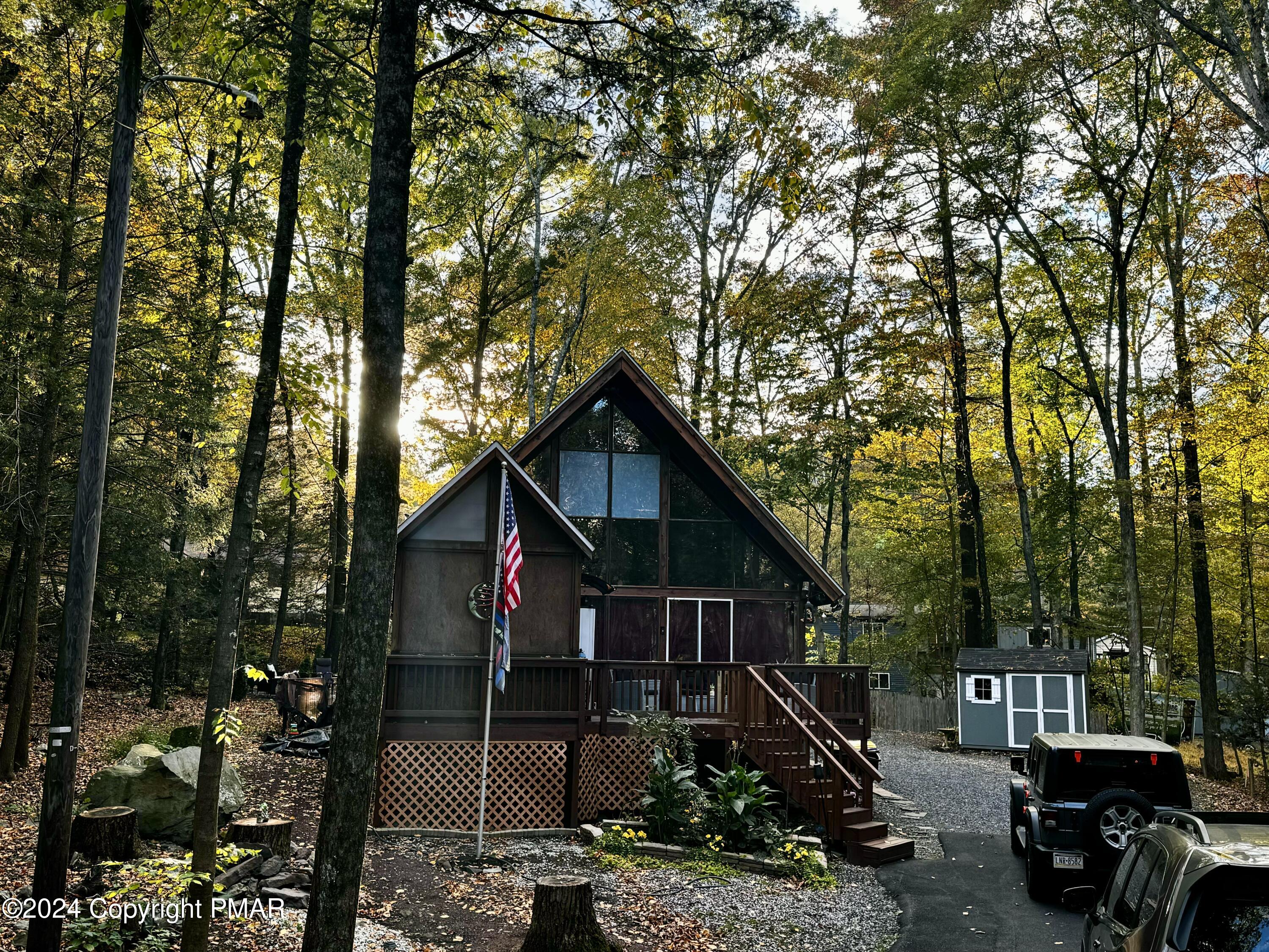 a front view of a house with cars parked