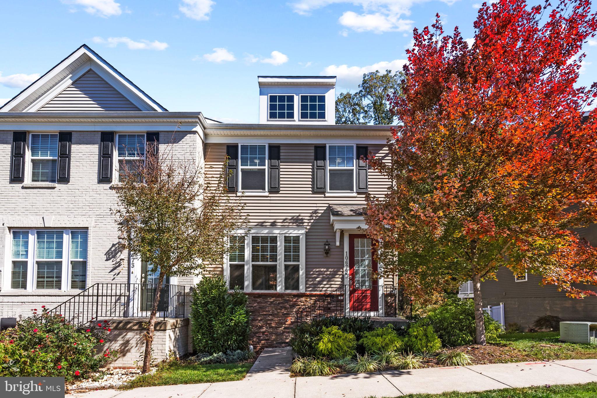 front view of a brick house with a yard