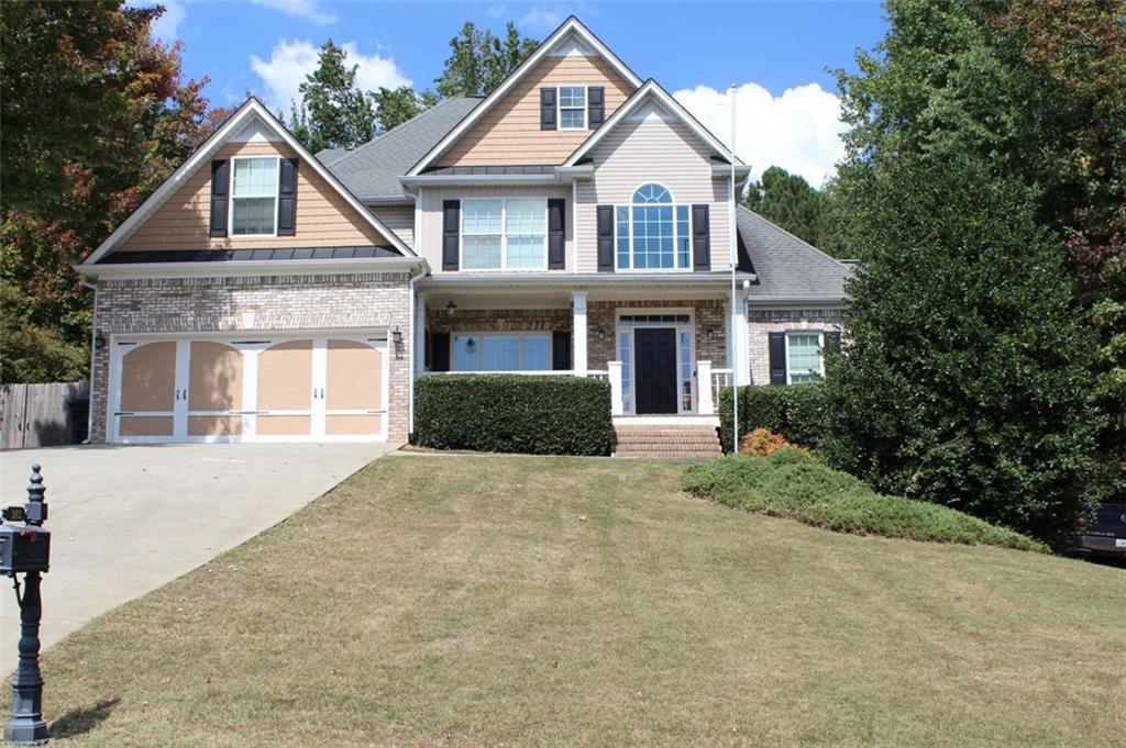 a front view of a house with a yard and garage