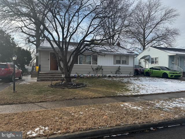 a view of a house with a yard covered with snow