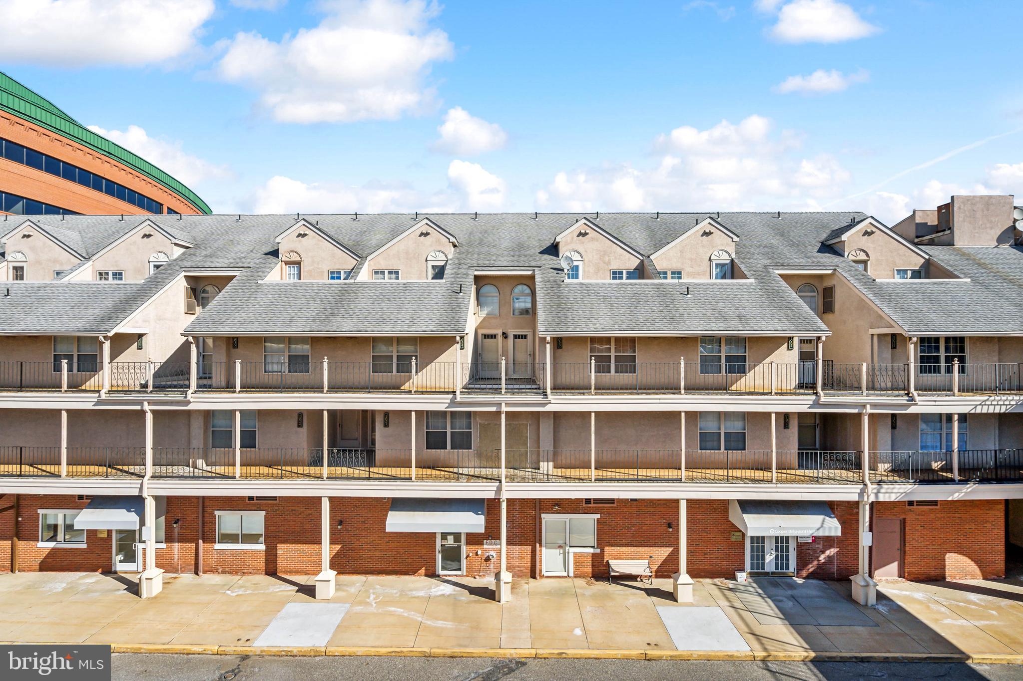 a view of a large building with a couple of houses