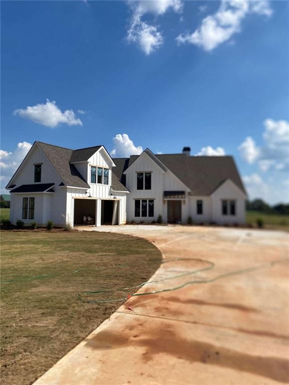 a front view of house with yard and trees