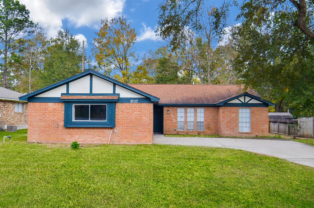 Stunning front view of this charming single-story home with a spacious lawn.