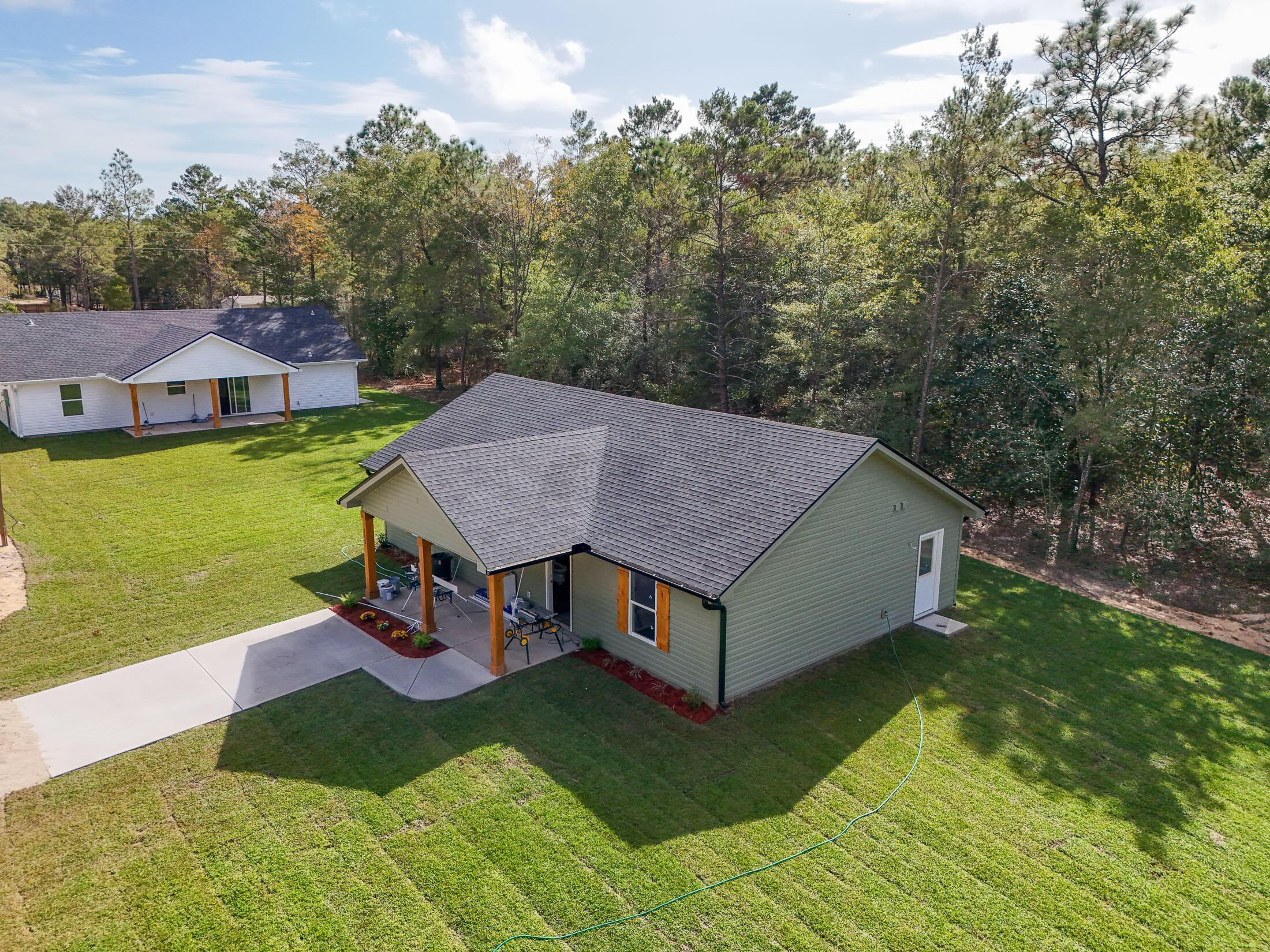 a aerial view of a house with yard porch and furniture