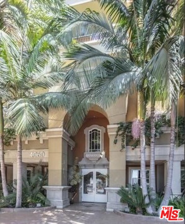 a view of a large building with a tree