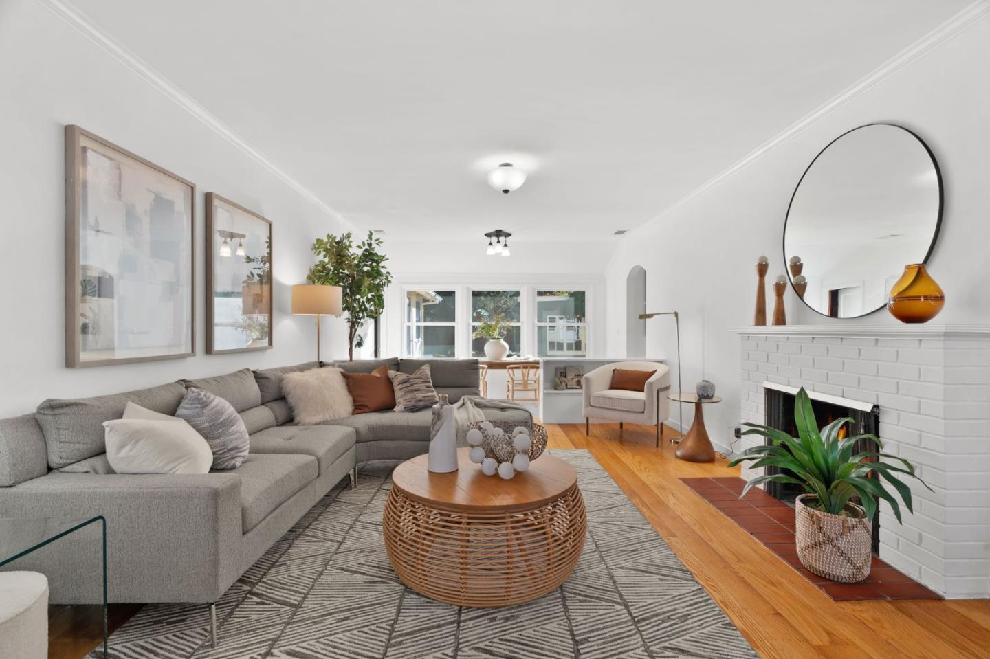 a living room with furniture a potted plant and a fireplace