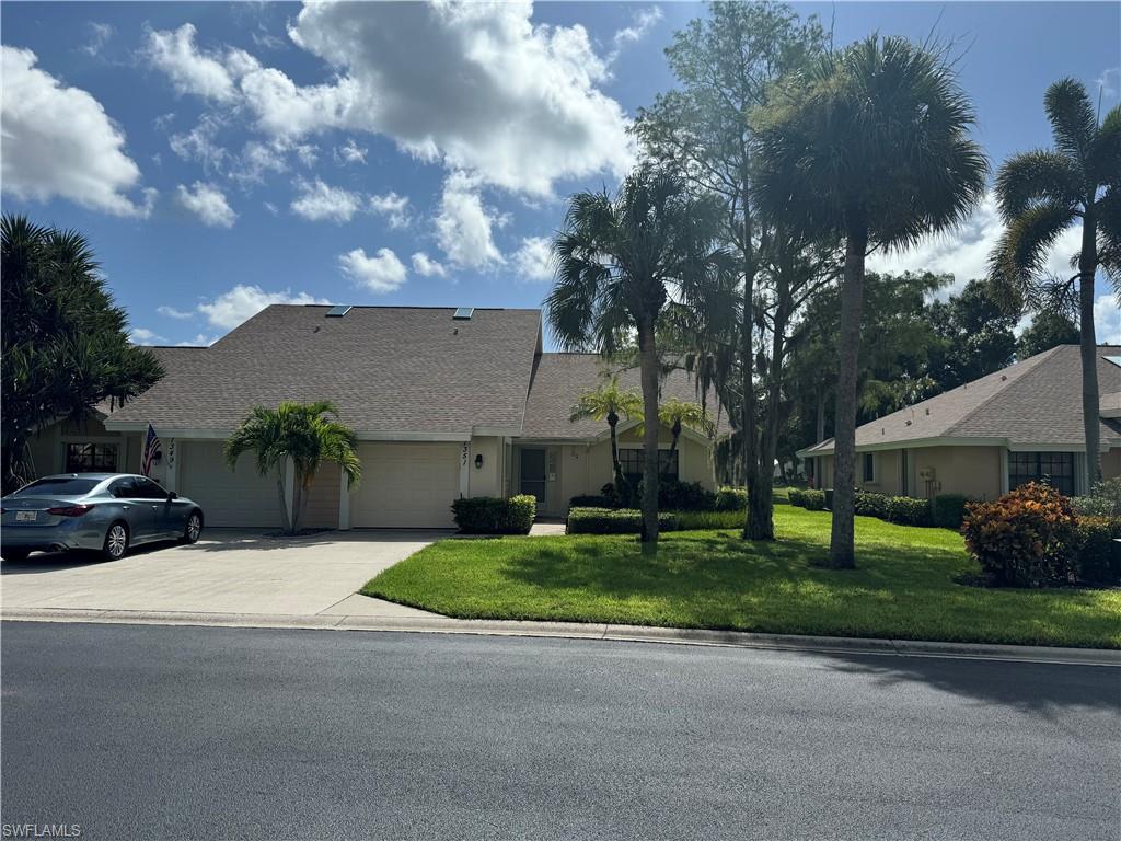 a view of a house with a yard and garage