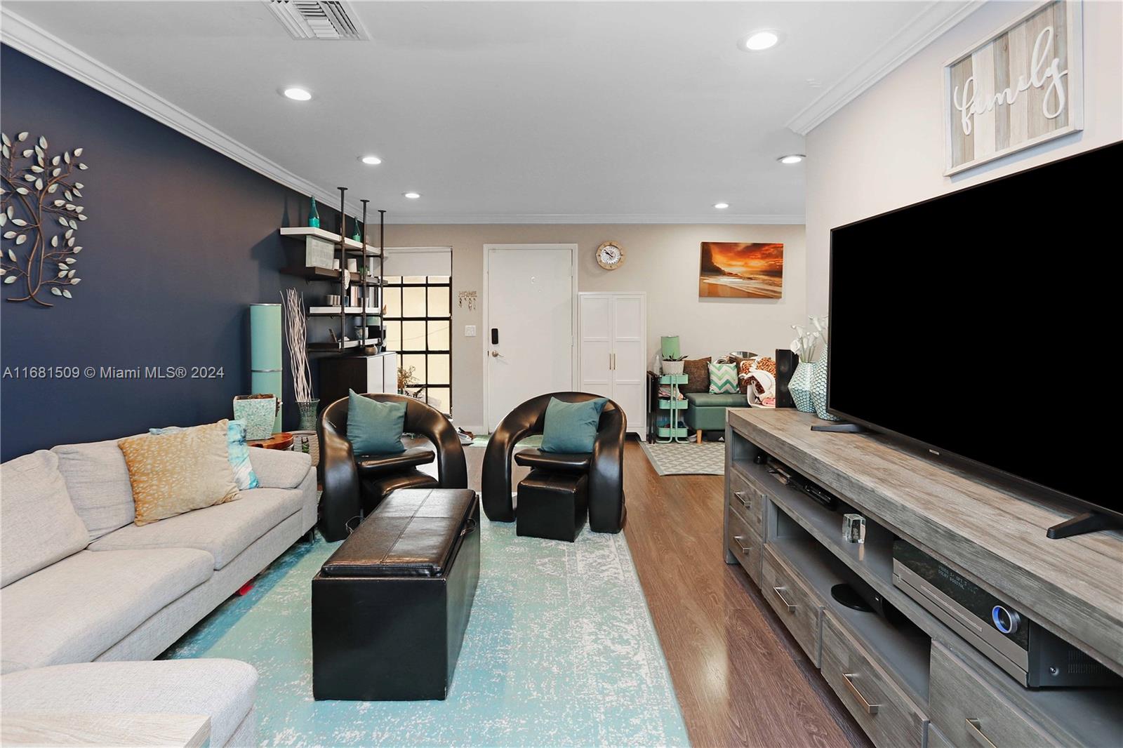 a living room with furniture and a flat screen tv