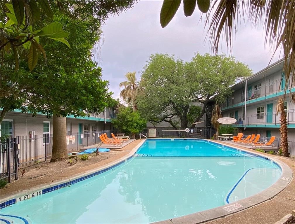 an outdoor space with swimming pool and furniture