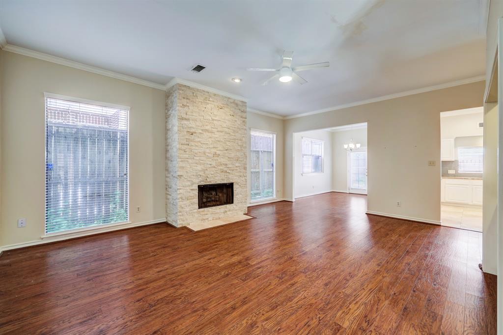 a view of empty room with wooden floor and fireplace