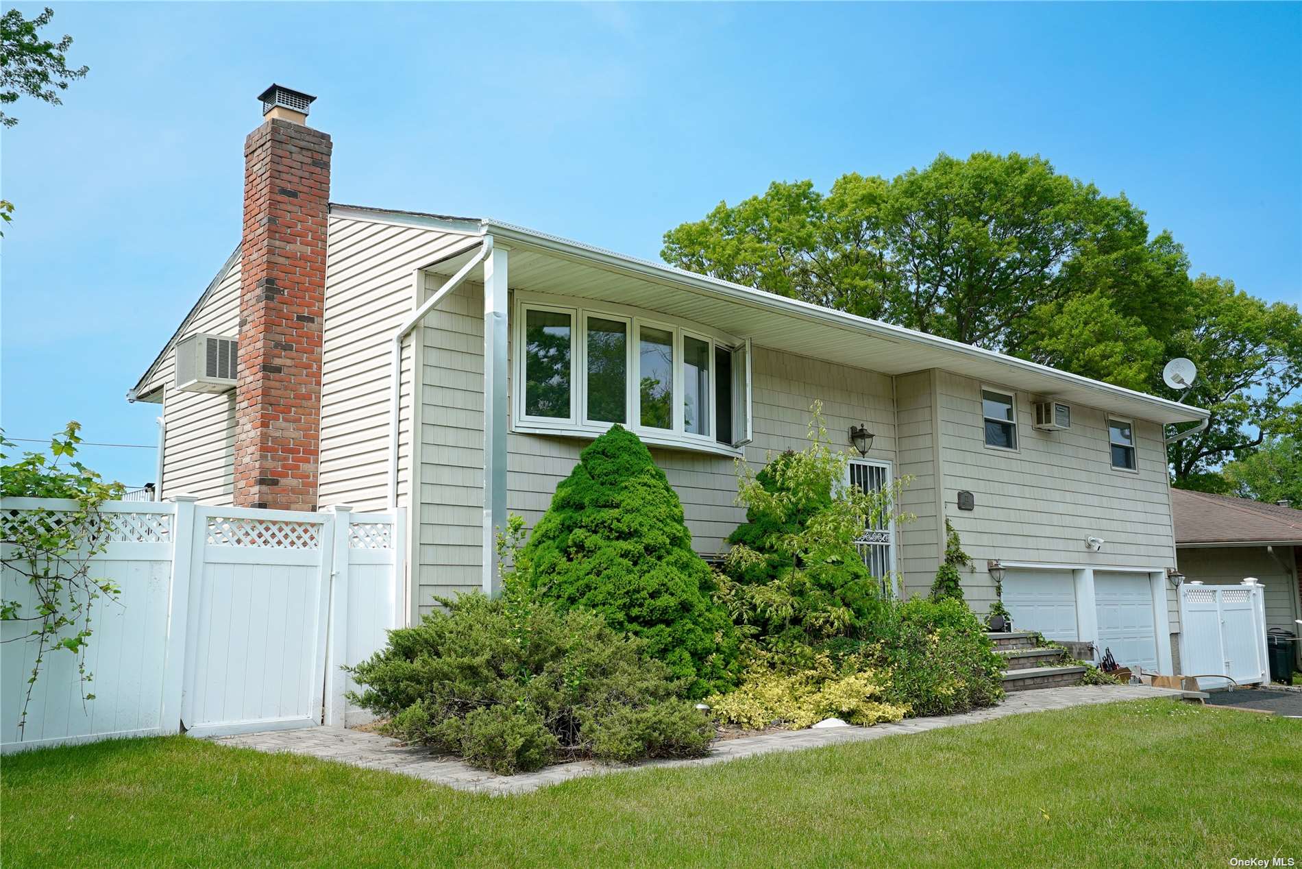 a front view of house with a garden