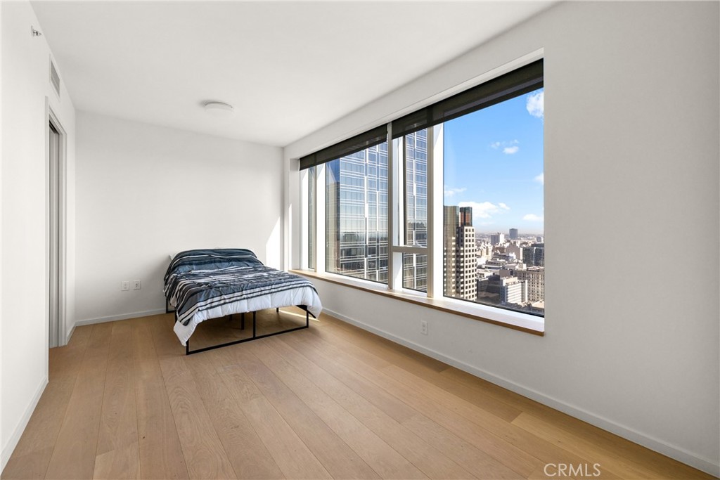 a bedroom with a bed and a large window