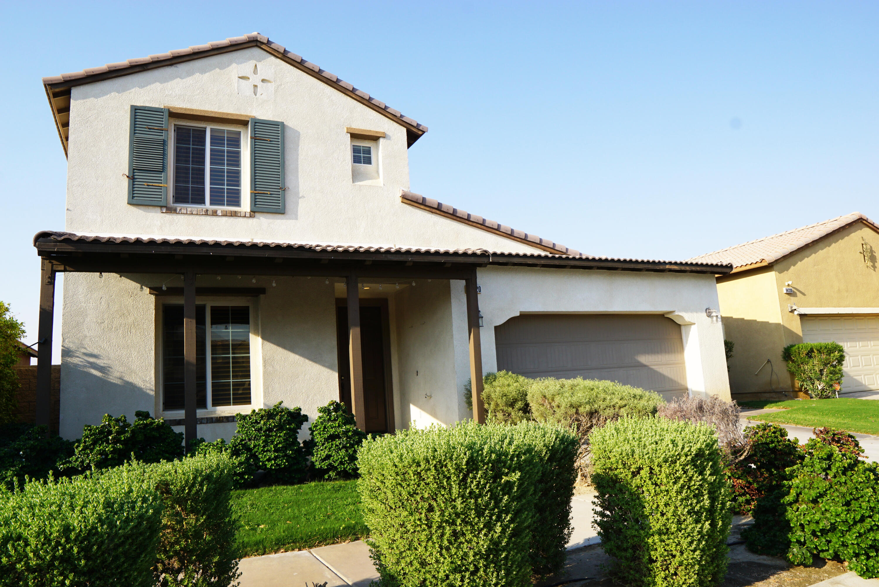 a front view of a house with garden