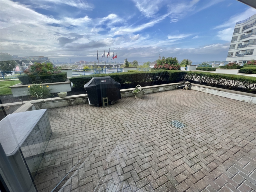 a view of a terrace with yard and mountain view in back