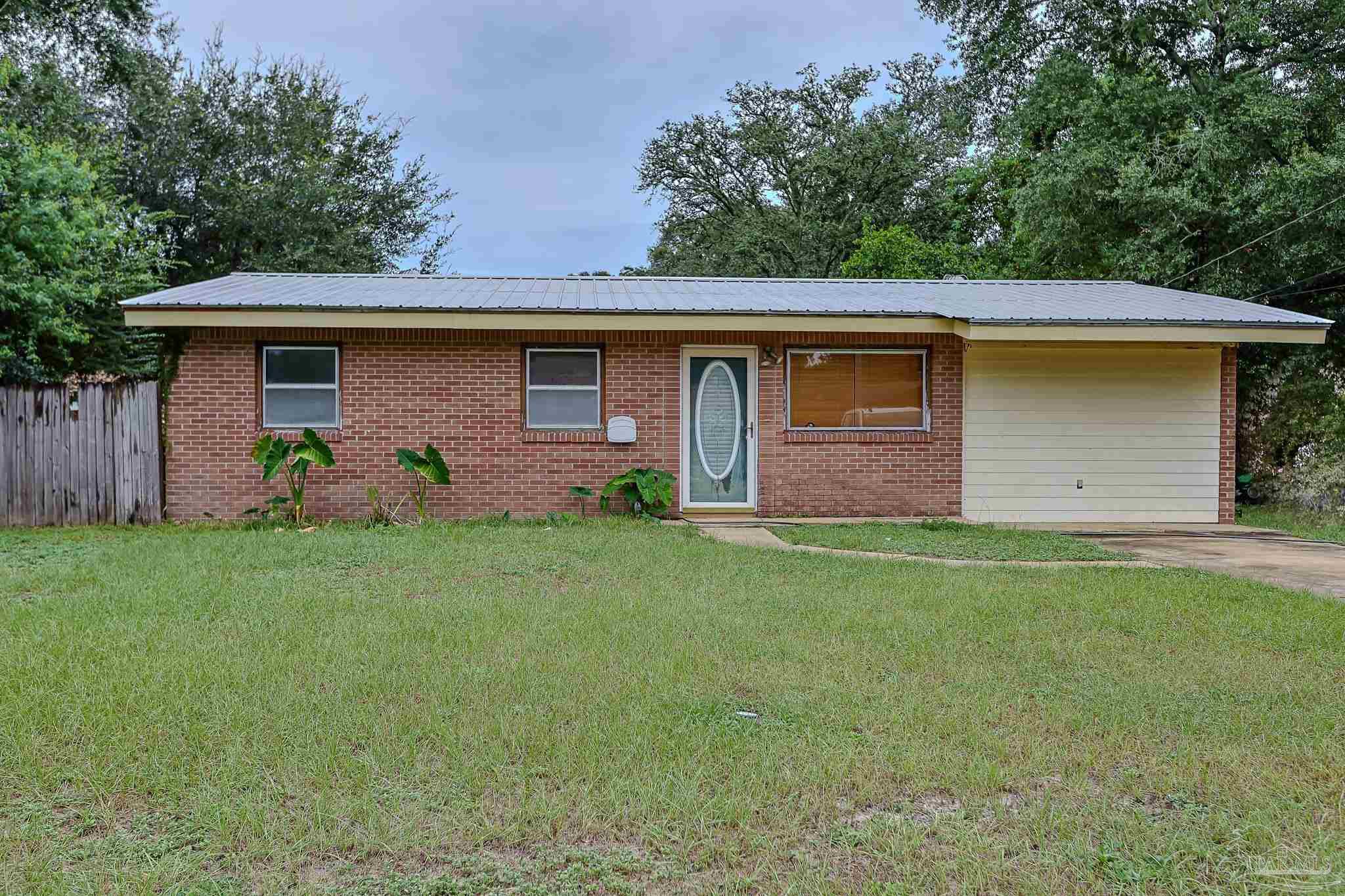 a front view of house with yard and trees