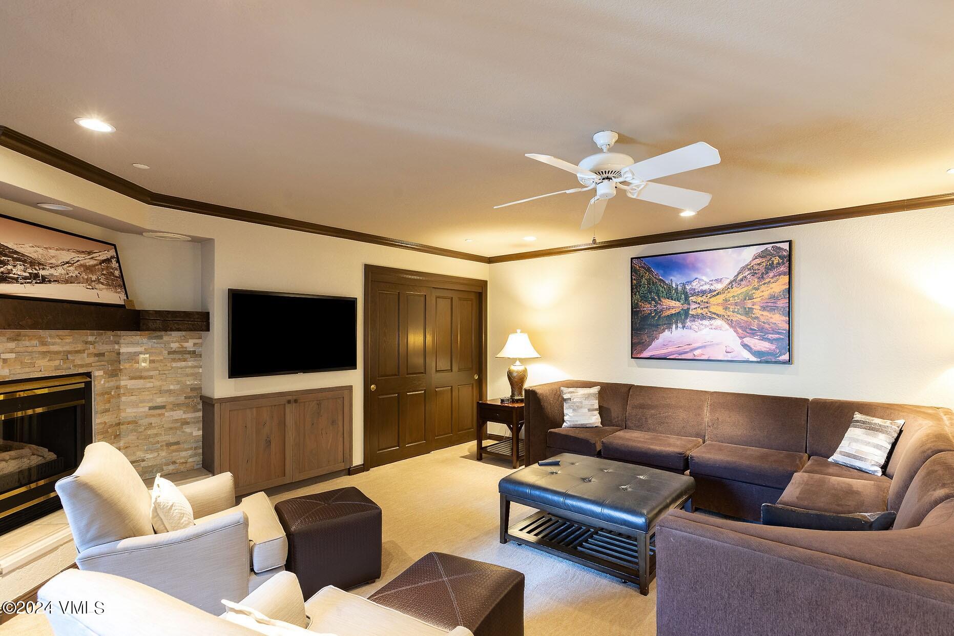 a living room with furniture a flat screen tv and a fireplace