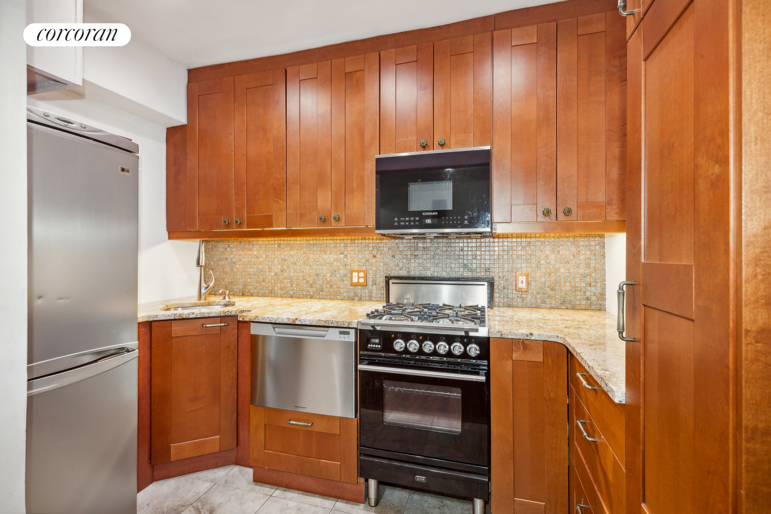 a kitchen with stainless steel appliances a stove a microwave and a sink