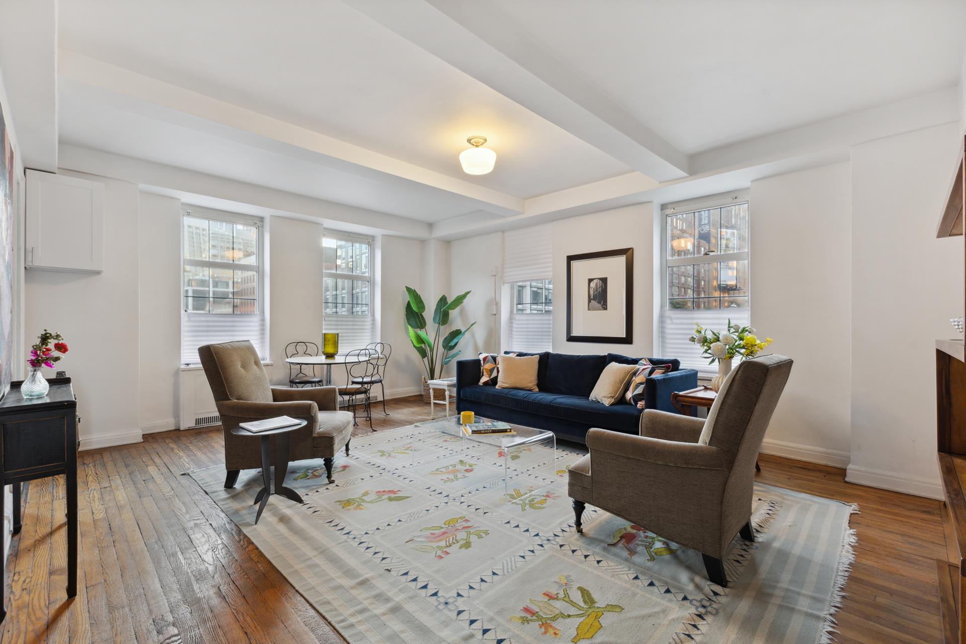 a living room with furniture and wooden floor