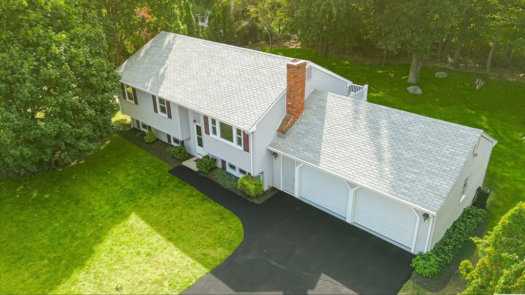 a view of a house with pool and a yard