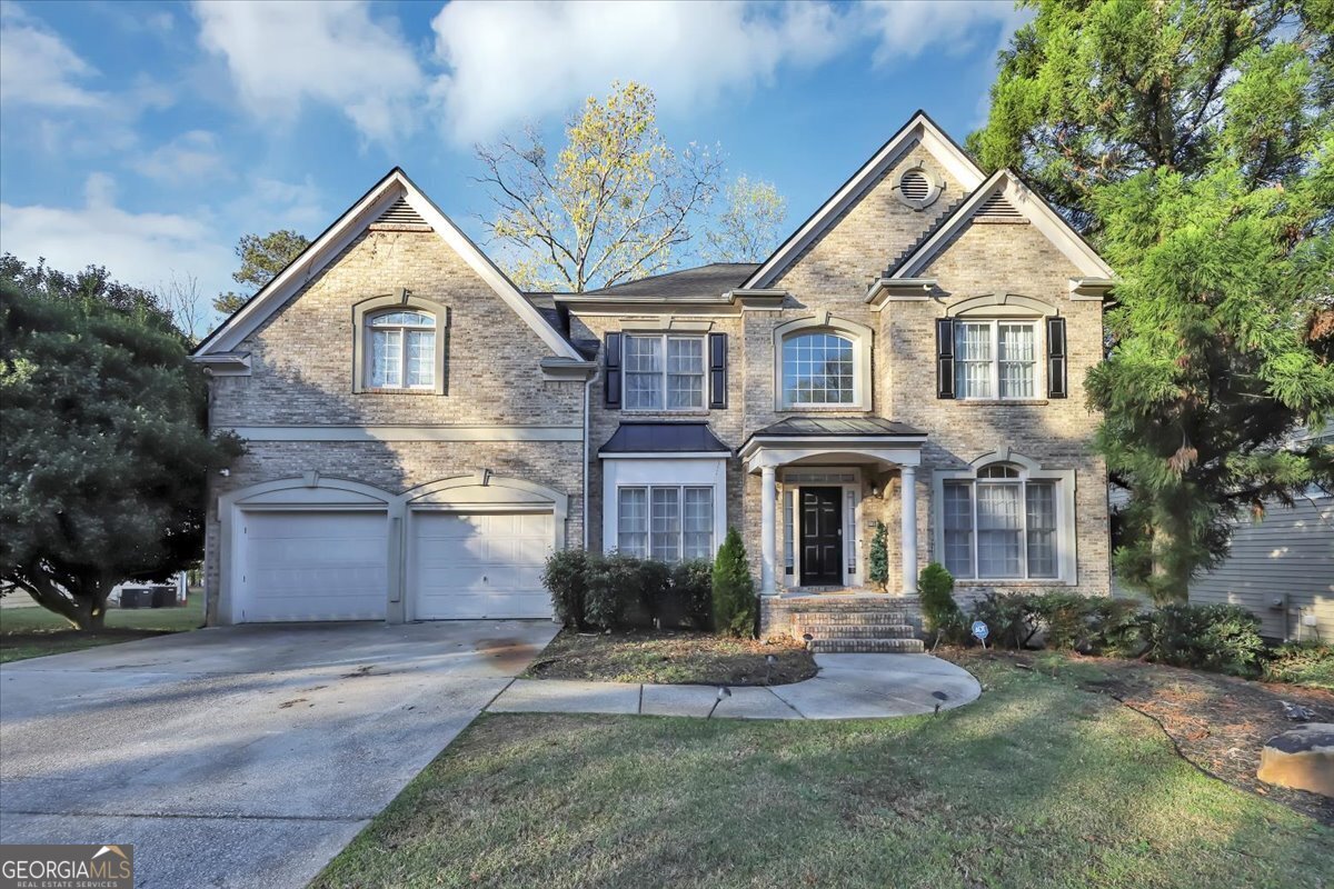 a front view of a house with a yard and garage