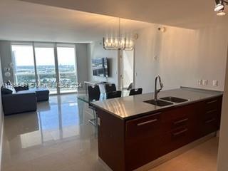 a kitchen with a sink and a large window