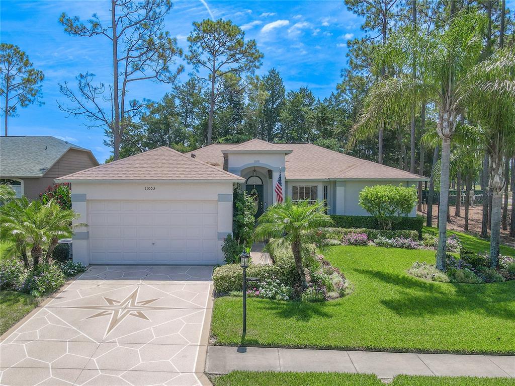 Curb appeal resounds with meticulously manicured grounds and a statement driveway.