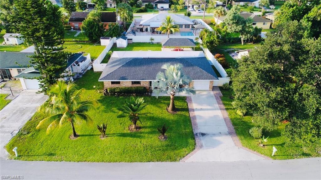 an aerial view of a house with a swimming pool yard and outdoor seating