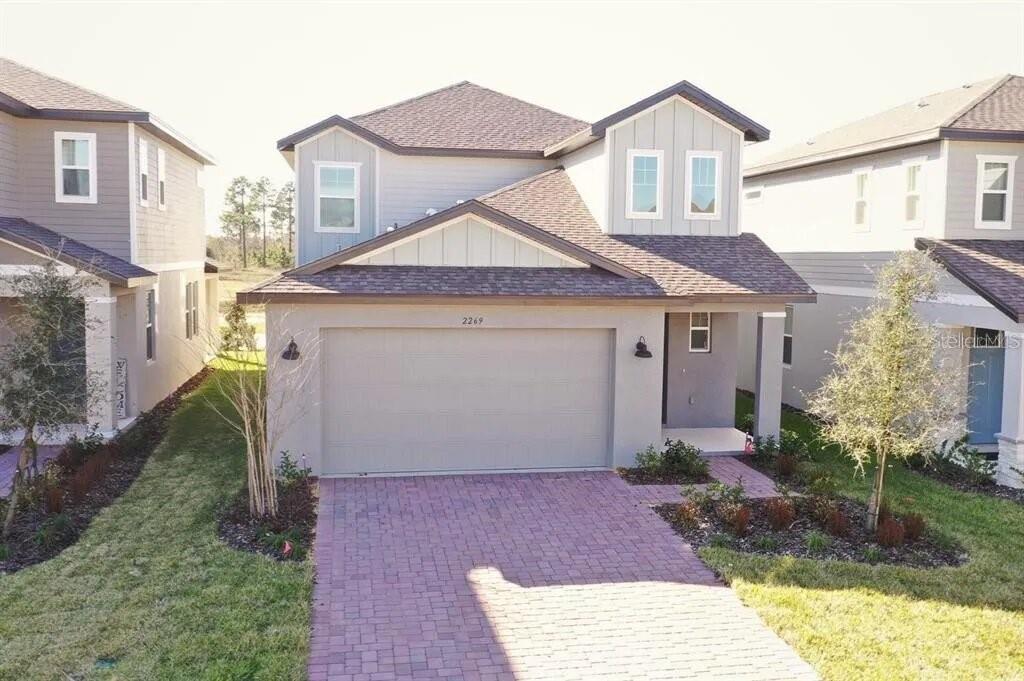 a front view of a house with a yard and garage