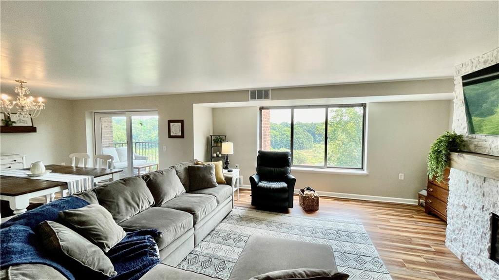 a living room with furniture large window and flat screen tv