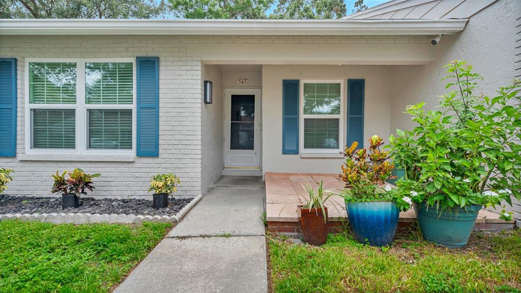 a front view of a house with potted plants