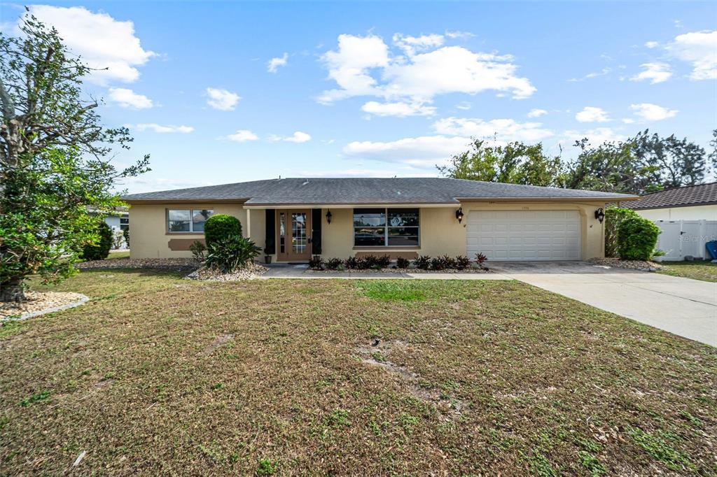 a front view of house with yard and green space