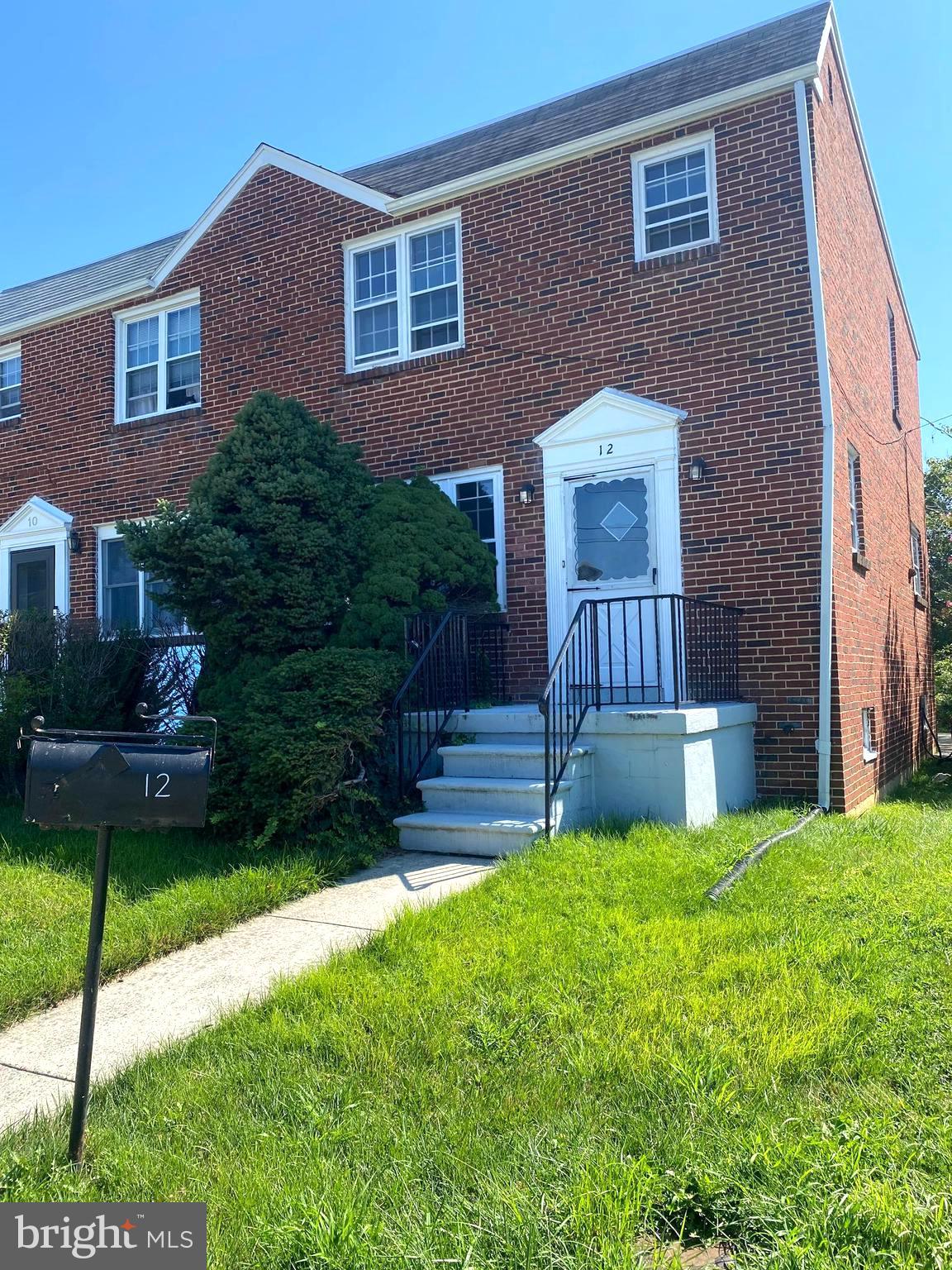 a view of a house with a yard and a garden