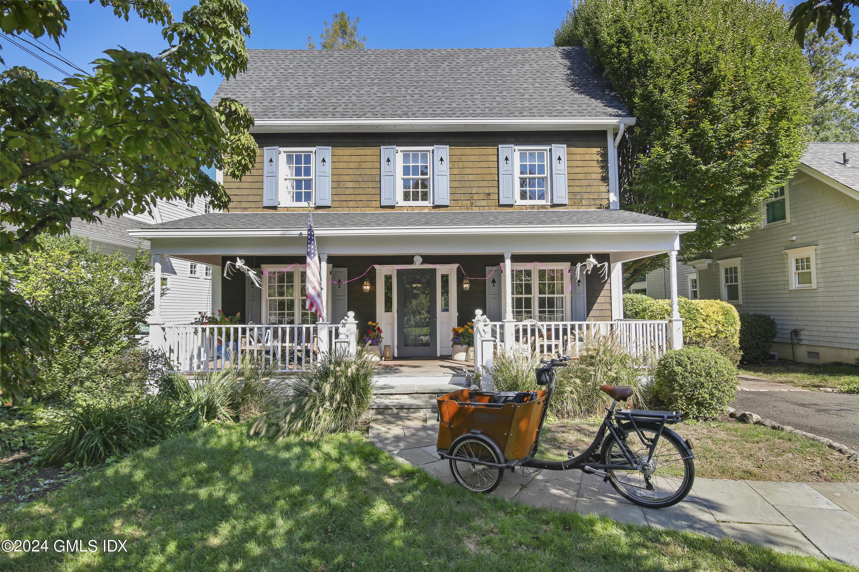 a house view with a table and chairs in a yard