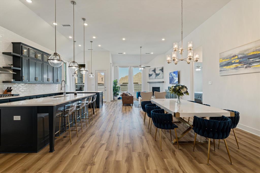 a large kitchen with a table and chairs