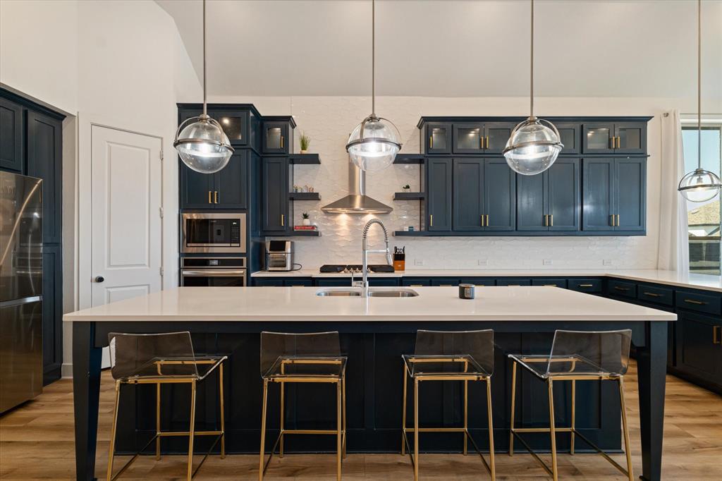 a kitchen with a refrigerator and microwave