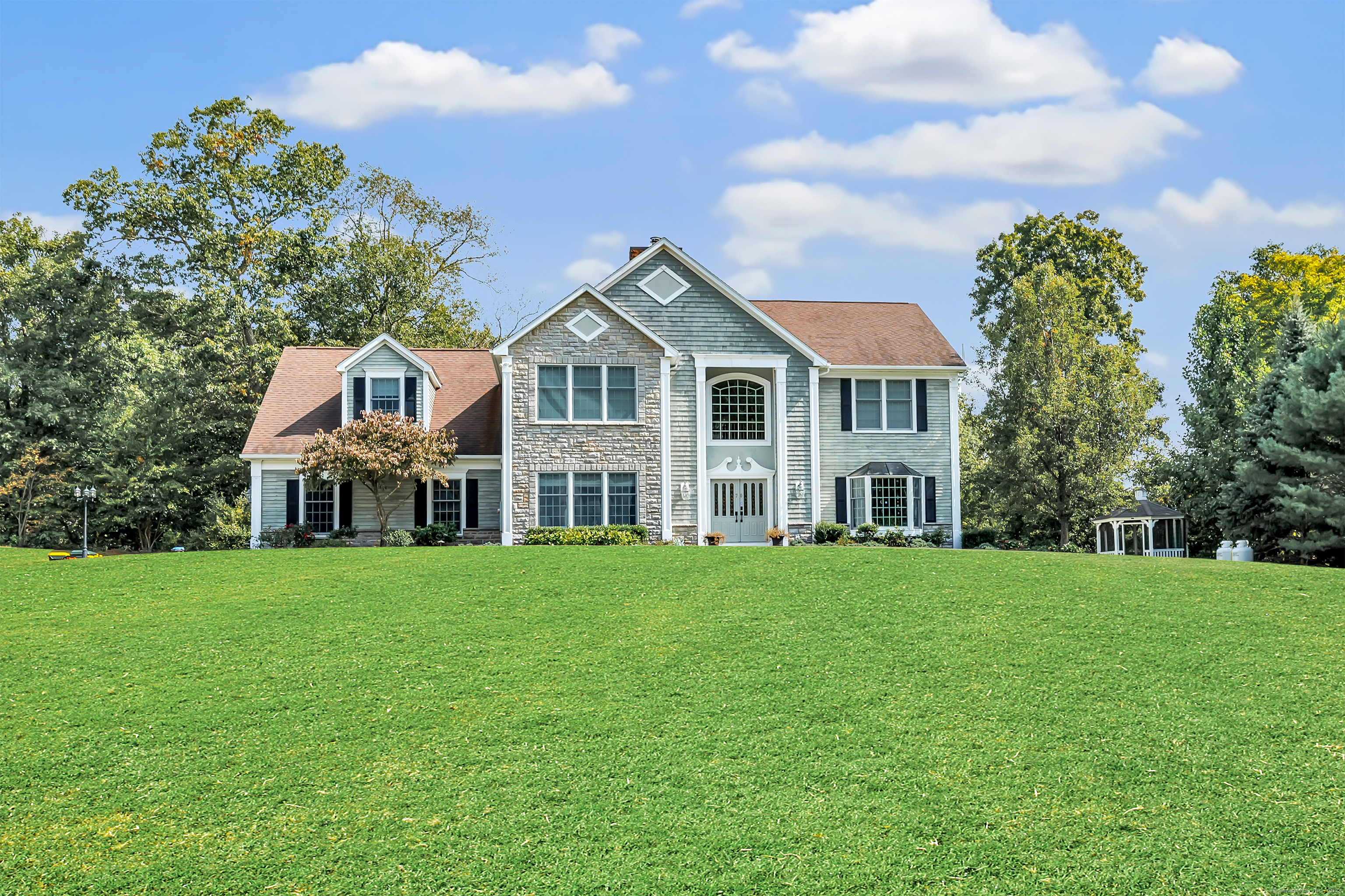 a front view of a house with a garden