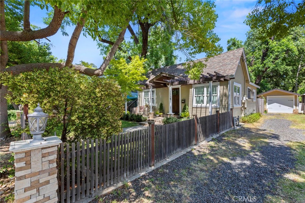 a view of a house with wooden fence