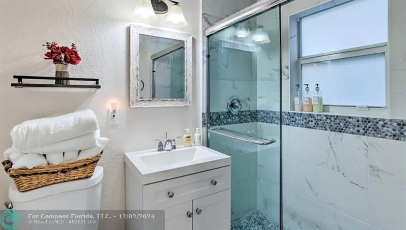 a bathroom with a sink mirror and vanity