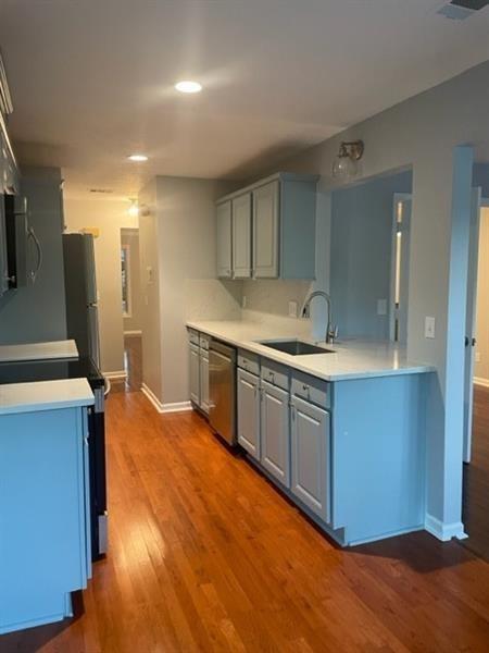 a kitchen with stainless steel appliances granite countertop a sink and a stove