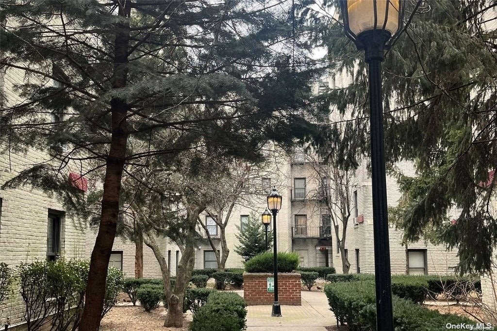 a front view of a building with trees