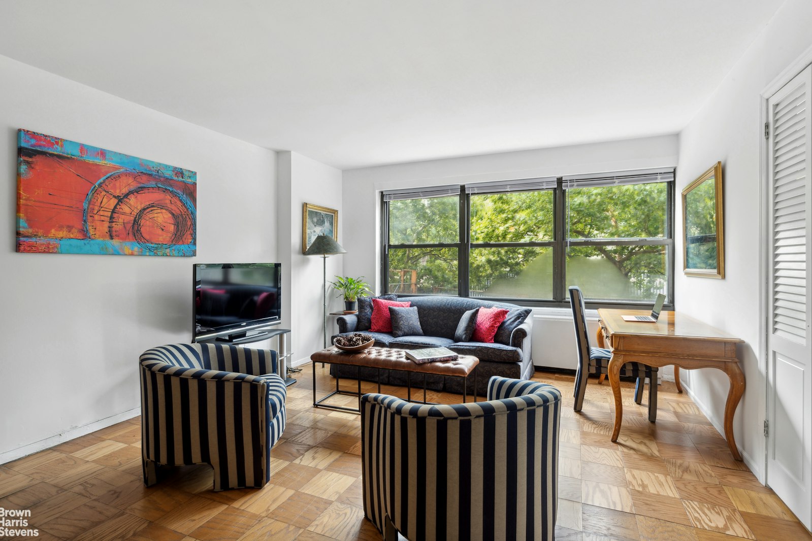 a living room with furniture and a flat screen tv