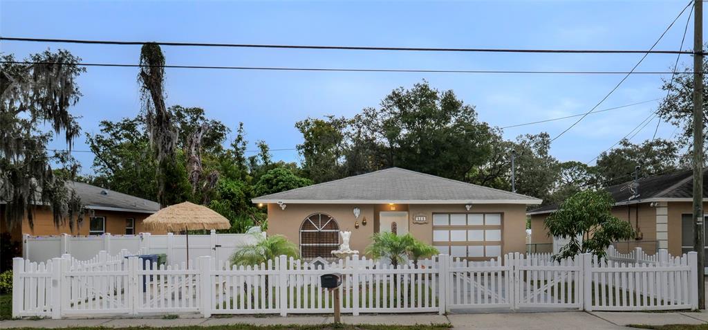 a front view of a house with yard and outdoor seating